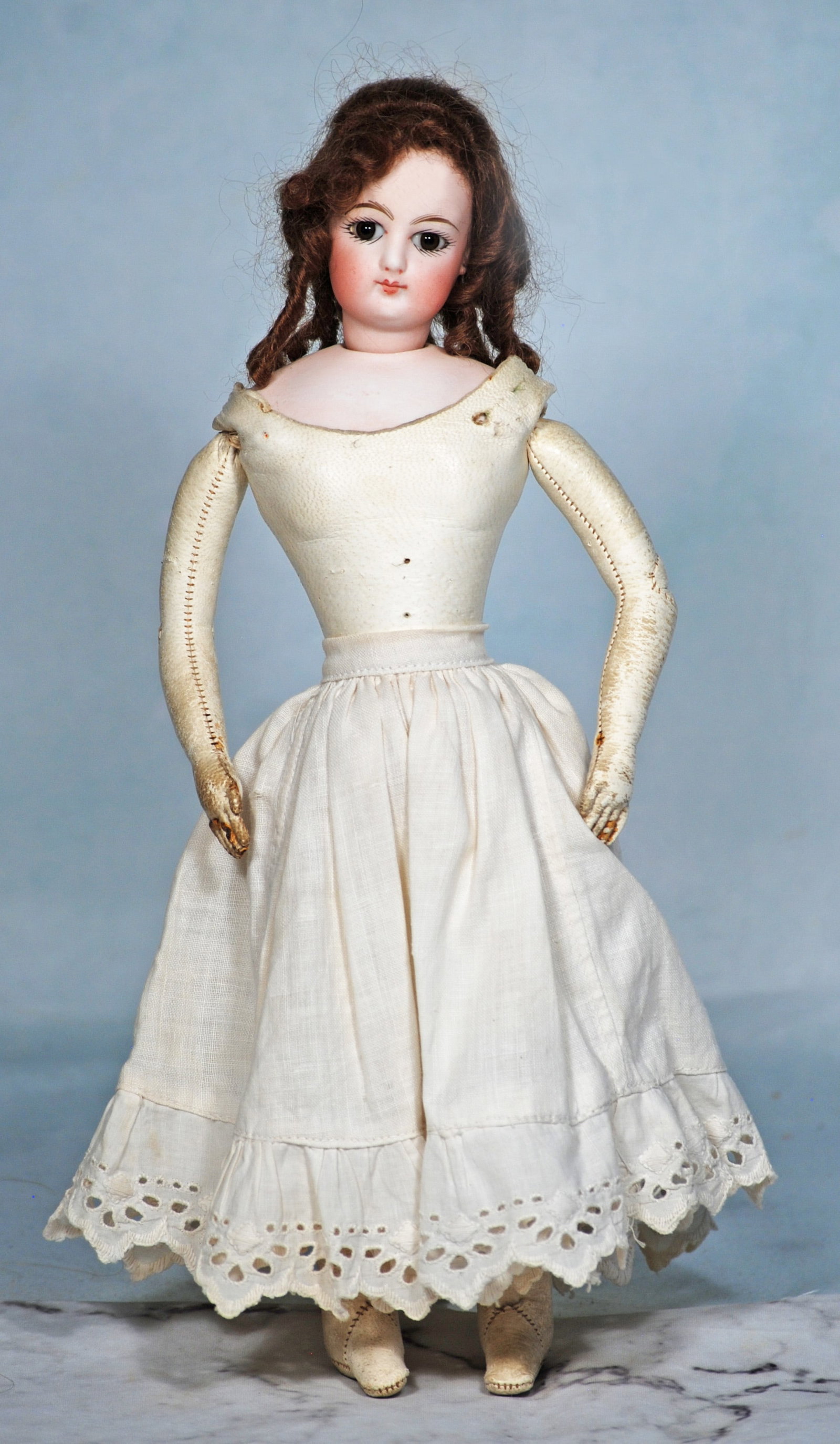 PETITE FRENCH BISQUE POUPEE BY GAULTHIER.: 5. PETITE FRENCH BISQUE POUPEE BY GAULTHIER. 11 ½”. Marks: 0 (head and shoulderplate). Bisque swivel head on bisque shoulderplate, inset brown glass eyes, painted lashes, feathered brows,