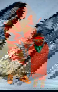 TWO SKOOKUMS DOLLS.: 9. TWO SKOOKUMS DOLLS. 7 ½” and 11”. Paper mache heads with painted features, mohair wigs, original blanket wrapped body. All-original, very good condition. Estimate: $100/300