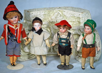 FOUR MINIATURE GERMAN BISQUE DOLLS IN ORIGINAL COSTUMES: 10. FOUR MINIATURE GERMAN BISQUE DOLLS IN ORIGINAL COSTUMES. 5” to 6”. Each has bisque socket head, five-piece jointed paper mache body with painted shoes and stockings, closed mouth,