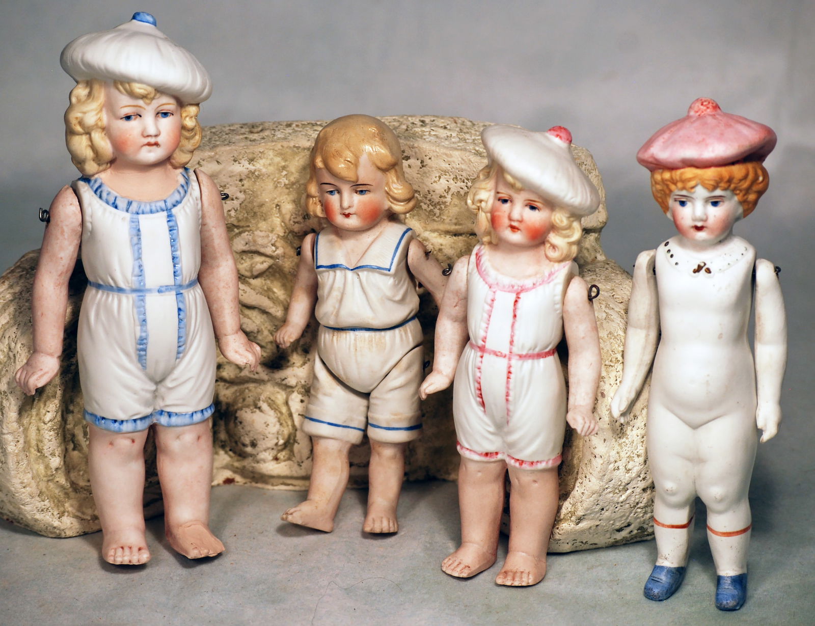 FOUR GERMAN ALL-BISQUE DOLLS. (1 of 1)