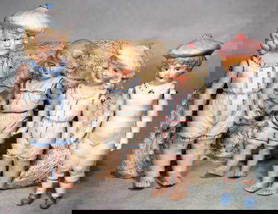 FOUR GERMAN ALL-BISQUE DOLLS.: 17. FOUR GERMAN ALL-BISQUE DOLLS. 6” to 7 ½”. Each is all-bisque with sculpted blonde hair and painted features. Three have sculpted bonnets and suits, bare feet; one has
