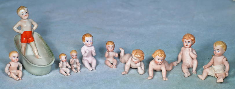 COLLECTION OF NINE MINIATURE ALL-BISQUE BABIES AND PORCELAIN DOLL IN BATH TUB.: 20. COLLECTION OF NINE MINIATURE ALL-BISQUE BABIES AND PORCELAIN DOLL IN BATH TUB. Nine molded one-piece nude all-bisque babies in various poses, painted hair and features, 1 ¼” to 2