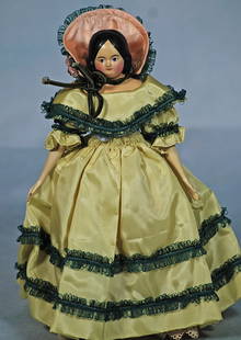 GERMAN PAPER MACHE MILLINER’S MODEL.: 23. GERMAN PAPER MACHE MILLINER’S MODEL. 10”. Paper mache shoulderhead, sculpted black hair, painted features, blue eyes, original slender kid leather body with carved wooden lower limbs,