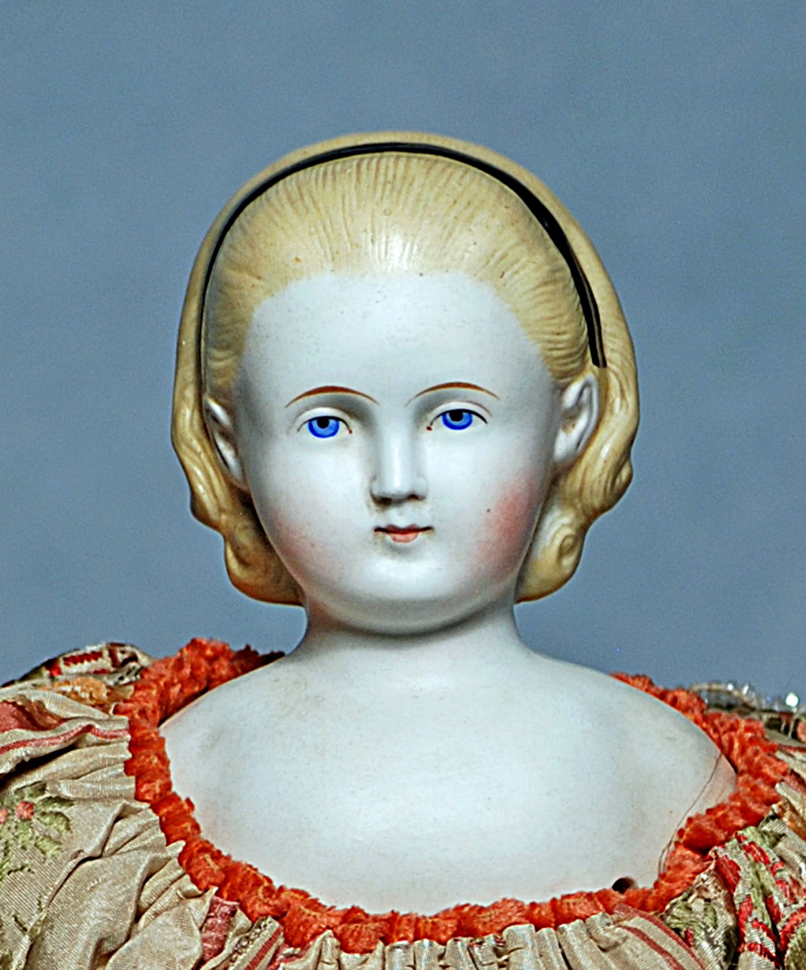 GERMAN BISQUE LADY KNOWN AS ALICE IN WONDERLAND: 31. GERMAN BISQUE LADY KNOWN AS “ALICE IN WONDERLAND”. 15”. Bisque shoulderhead, sculpted blonde hair drawn away from the face and secured by black hair band, fully modeled ears, painted