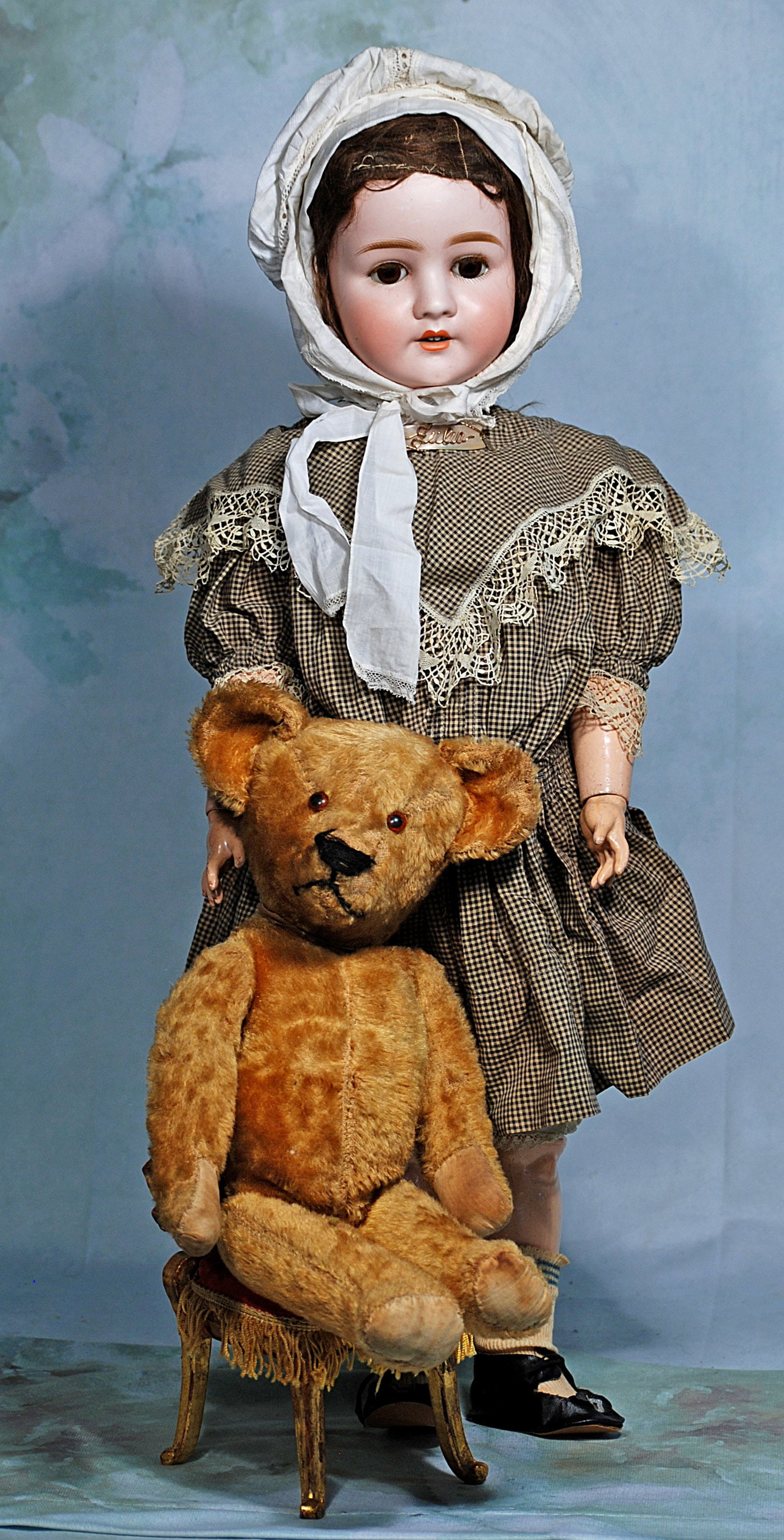 .GERMAN BISQUE CHILD BY SCHOENAU & HOFFMEISTER WITH ANTIQUE TEDDY BEAR.: 49. GERMAN BISQUE CHILD BY SCHOENAU & HOFFMEISTER WITH ANTIQUE TEDDY BEAR. 27”. Marks: S PB H 914, Bisque socket head, brown sleep eyes, painted lashes, feathered brows, open mouth, accented lip