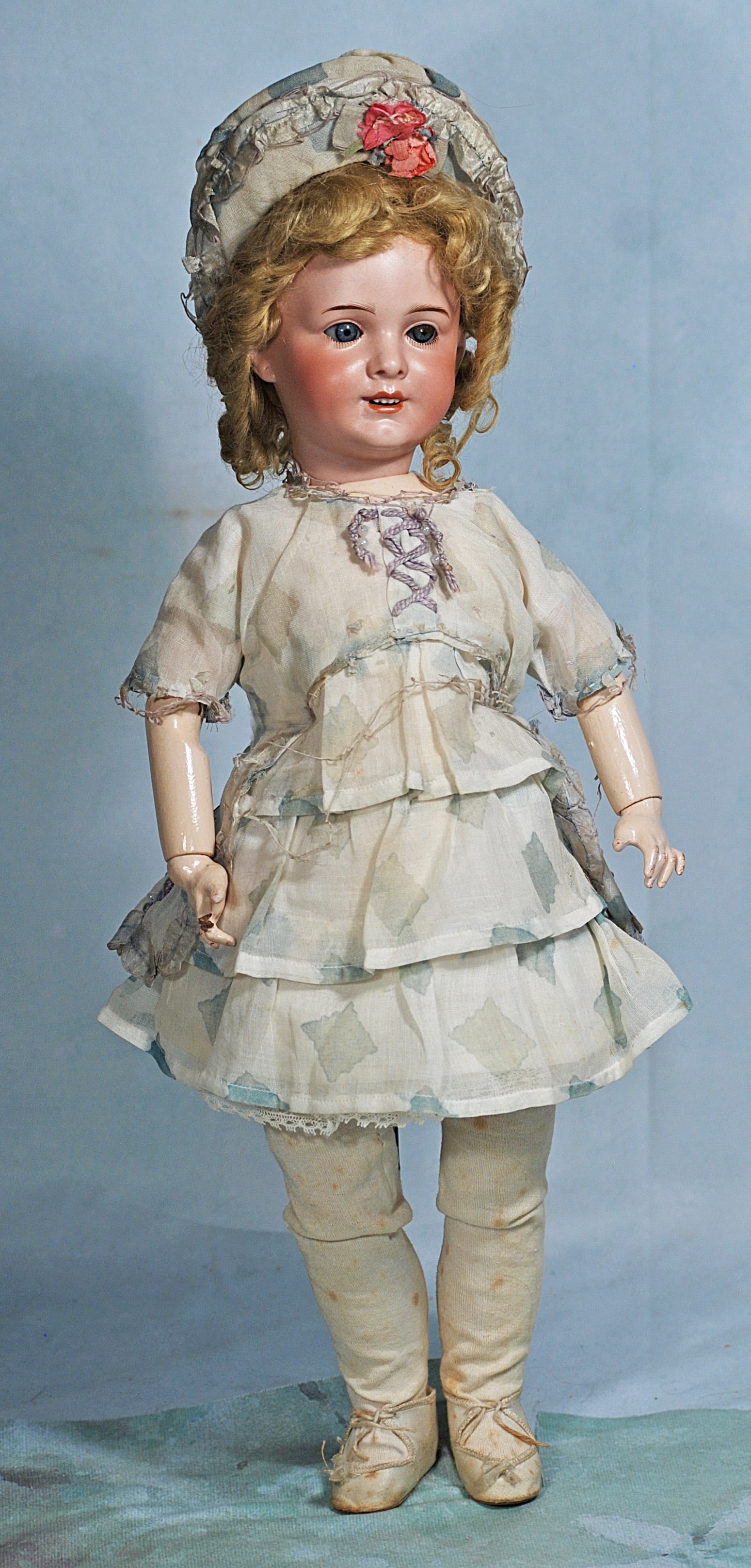 FRENCH BISQUE BEBE BY S.F.B.J.: 81. FRENCH BISQUE BEBE BY S.F.B.J. 18”. Marks: SFBJ 230 Paris. Bisque socket head, blue sleep eyes, applied upper lashes, painted lower lashes, feathered brows, pierced ears, open mouth, accente