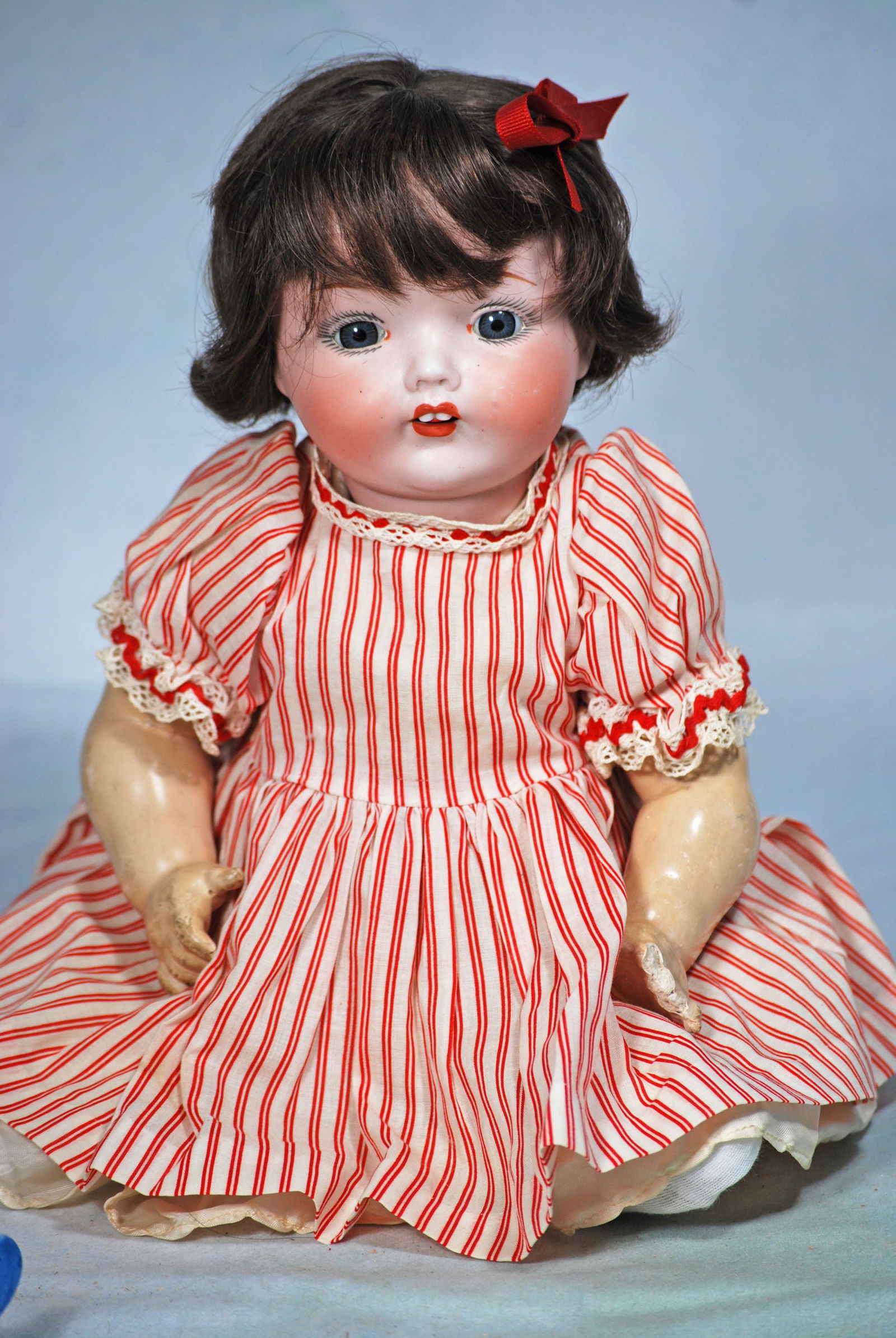 BISQUE CHARACTER BABY BY FULPER.: 82. BISQUE CHARACTER BABY BY FULPER. 15”. Marks: Fulper USA. Bisque socket head, stationary blue glass eyes, painted lashes and brows, open mouth, two upper teeth, brunette human hair wig, compo