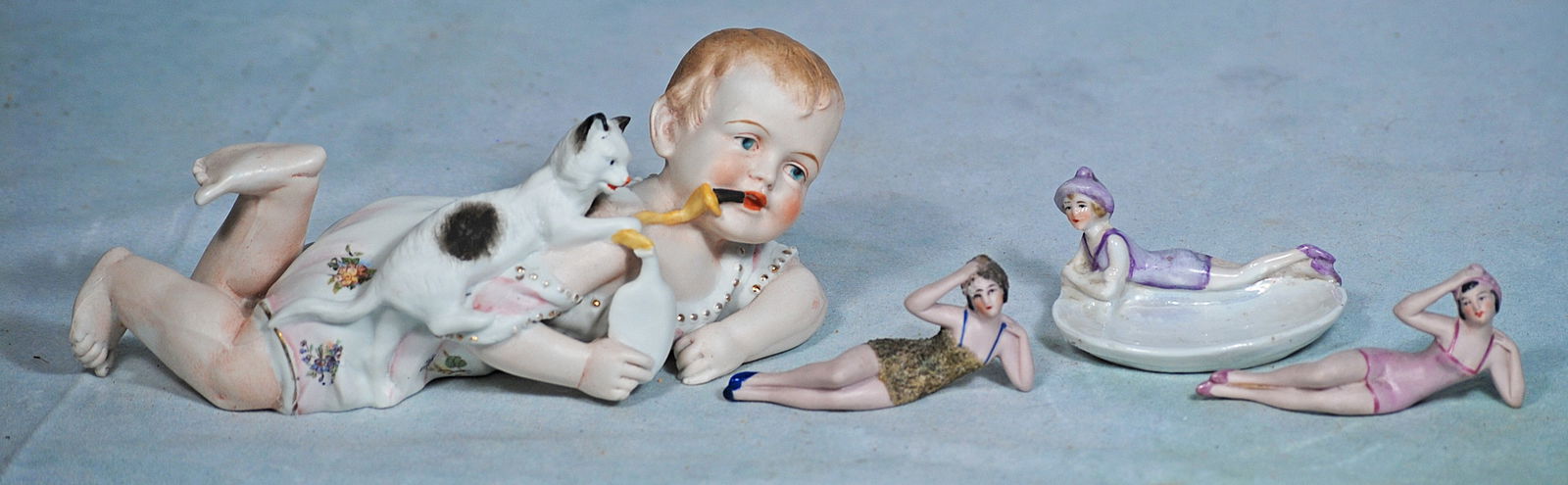 THREE PORCELAIN BATHING BEAUTIES AND GERMAN BISQUE PIANO BABY (1 of 1)