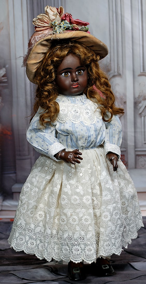 FRENCH BROWN-COMPLEXIONED E.D. BEBE BY DENAMUR.: FRENCH BROWN-COMPLEXIONED E.D. BEBE BY DENAMUR. 22". Marks: E. 8 D. Depose. Bisque socket head with rich brown complexion, inset brown paperweight eyes, painted lashes, eyeliner, black feathered and b