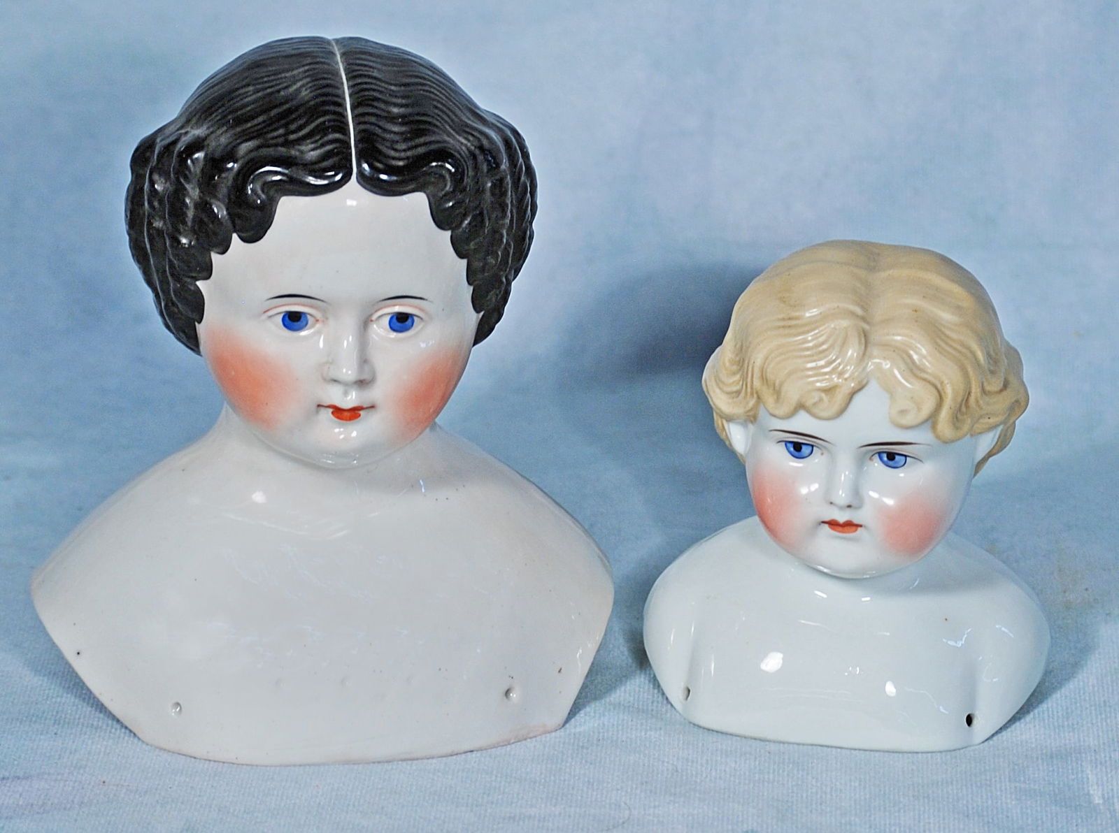 TWO PORCELAIN CHINA DOLL HEADS. (1 of 1)