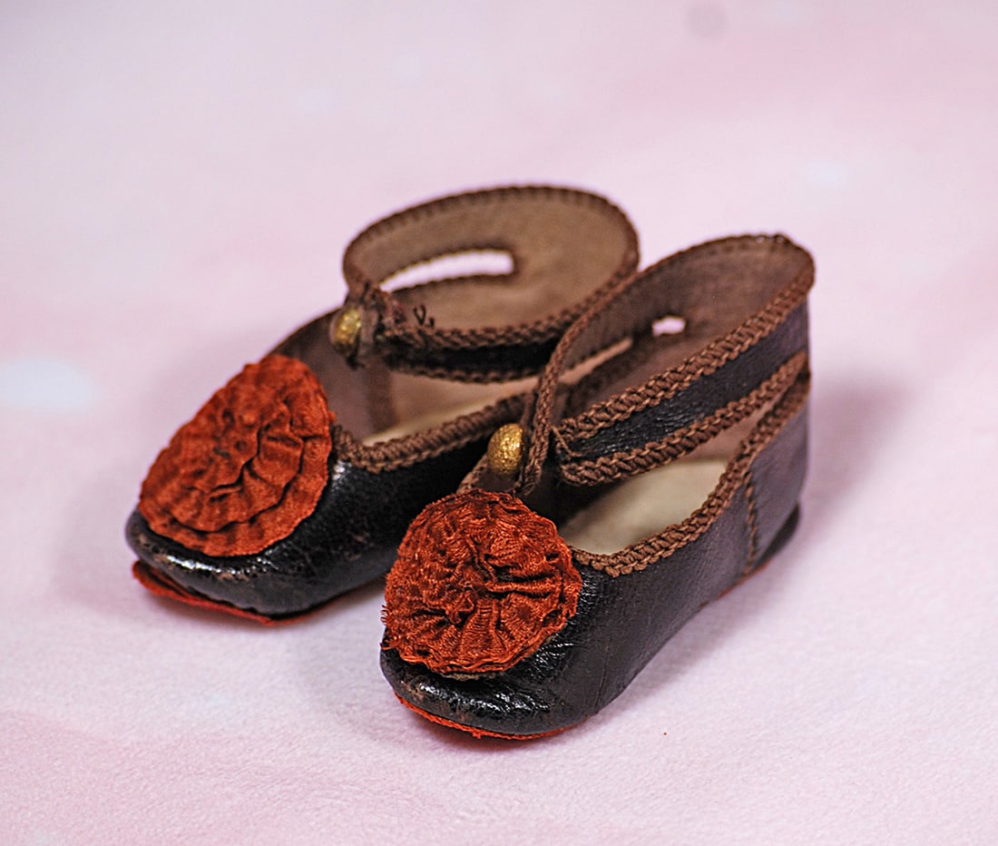 PAIR OF ANTIQUE DOLL SHOES.  Dark leather shoes with ankle-strap closing, overcast edges, large silk (1 of 1)