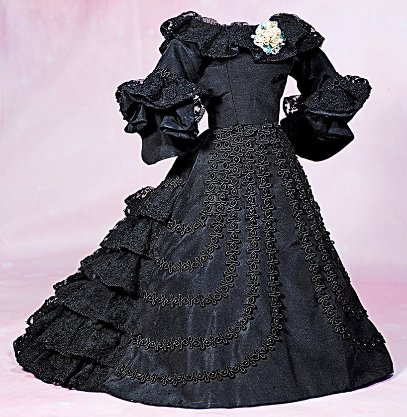BLACK SILK TAFFETA FASHION GOWN. Black silk one-piece gown has fitted bodice, scooped neckline,: BLACK SILK TAFFETA FASHION GOWN. Black silk one-piece gown has fitted bodice, scooped neckline, bell-shaped sleeves, smooth front skirt lavishly-decorated with black braid and sequins, gathered back s