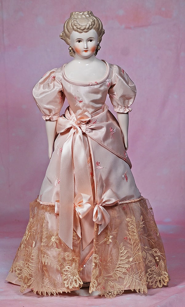 PORCELAIN LADY WITH ELABORATE COIFFURE BY EMMA CLEAR. 18”. Marks: Clear. Porcelain: PORCELAIN LADY WITH ELABORATE COIFFURE BY EMMA CLEAR. 18”. Marks: Clear. Porcelain shoulderhead, sculpted brown hair waved away at the sides with braided detail and coronet with braids draped do
