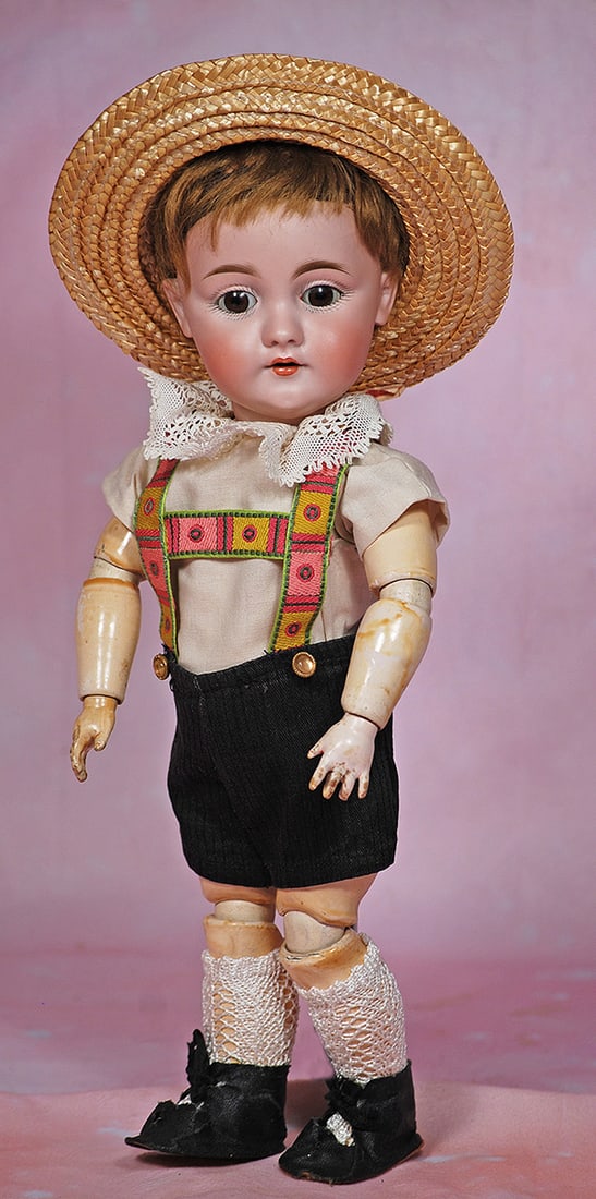 GERMAN BISQUE CHILD, MODEL 143, BY KESTNER. 14”. Marks: P. made in Germany 14, 143. Bisque: GERMAN BISQUE CHILD, MODEL 143, BY KESTNER. 14”. Marks: P. made in Germany 14, 143. Bisque socket head, brown sleep eyes, painted lashes, feathered brows, open mouth, accented lips, two upper te