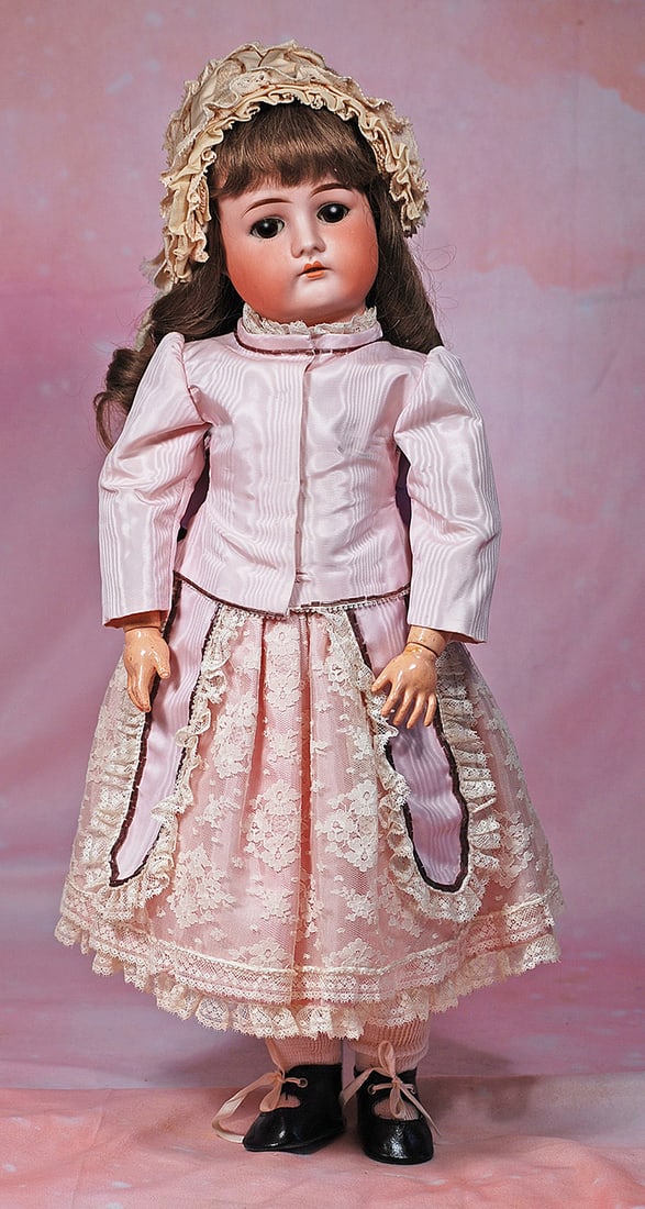 GERMAN BISQUE DOLL BY DRESSEL. n: GERMAN BISQUE DOLL BY DRESSEL. 20”. Marks: Made in Germany 1912. Bisque socket head, brown sleep eyes, painted and applied lashes, feathered brows, open mouth, upper teeth, brown human hair wig,