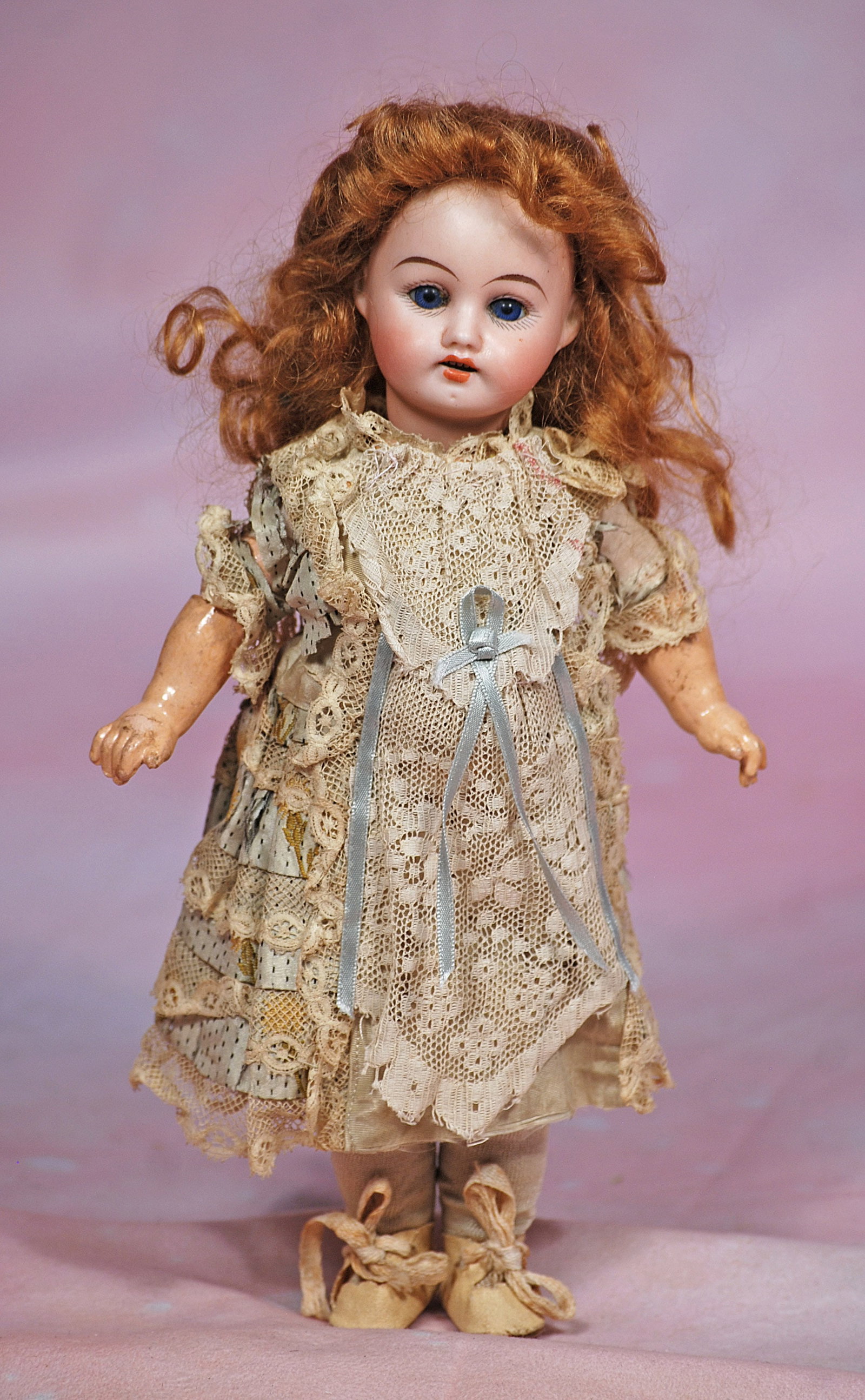 PETITE GERMAN BISQUE DOLL IN ORIGINAL DRESS.: 10. PETITE GERMAN BISQUE DOLL IN ORIGINAL DRESS. 10”. Marks: R. Dep 6/0. Bisque socket head, stationary blue glass eyes, painted lashes, tapered brows, open mouth, upper teeth, auburn mohair wig