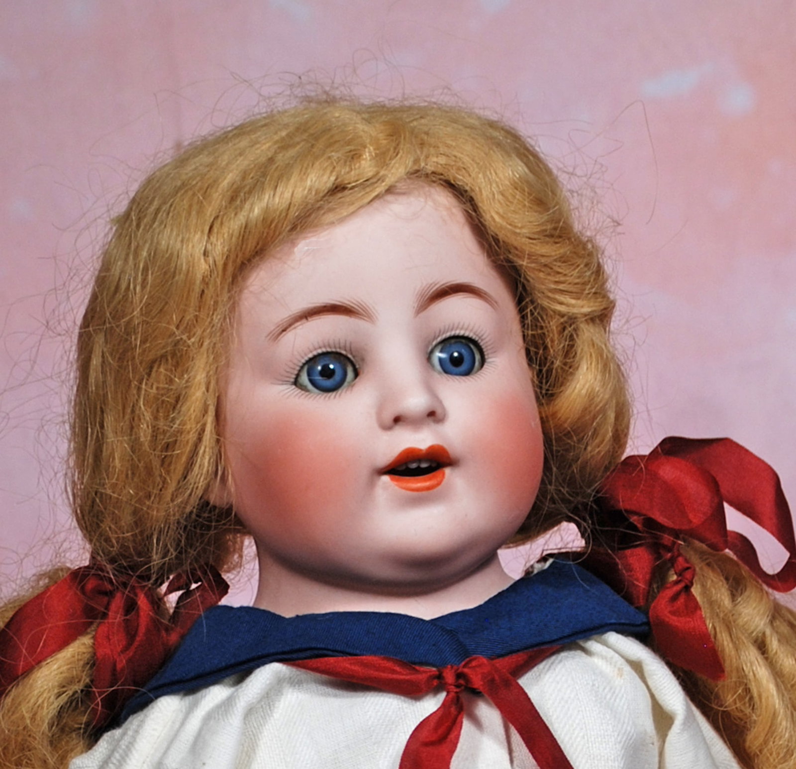 GERMAN BISQUE CHARACTER BY K & K TOY CO.: 45. GERMAN BISQUE CHARACTER BY K & K TOY CO. 23”. Marks: K & K 56 made in Germany. Bisque shoulderhead, blue sleep eyes, painted lashes, feathered brows, open mouth, upper teeth, blonde mohair w