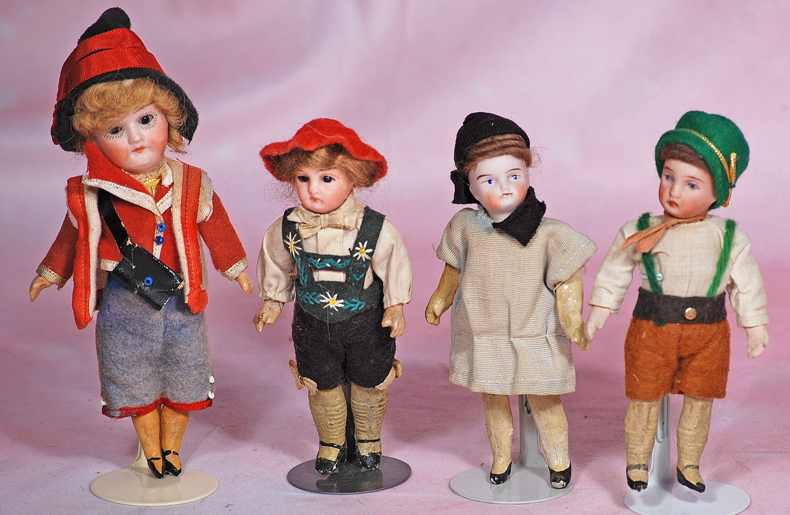 FOUR MINIATURE GERMAN BISQUE DOLLS IN ORIGINAL COSTUMES (1 of 1)