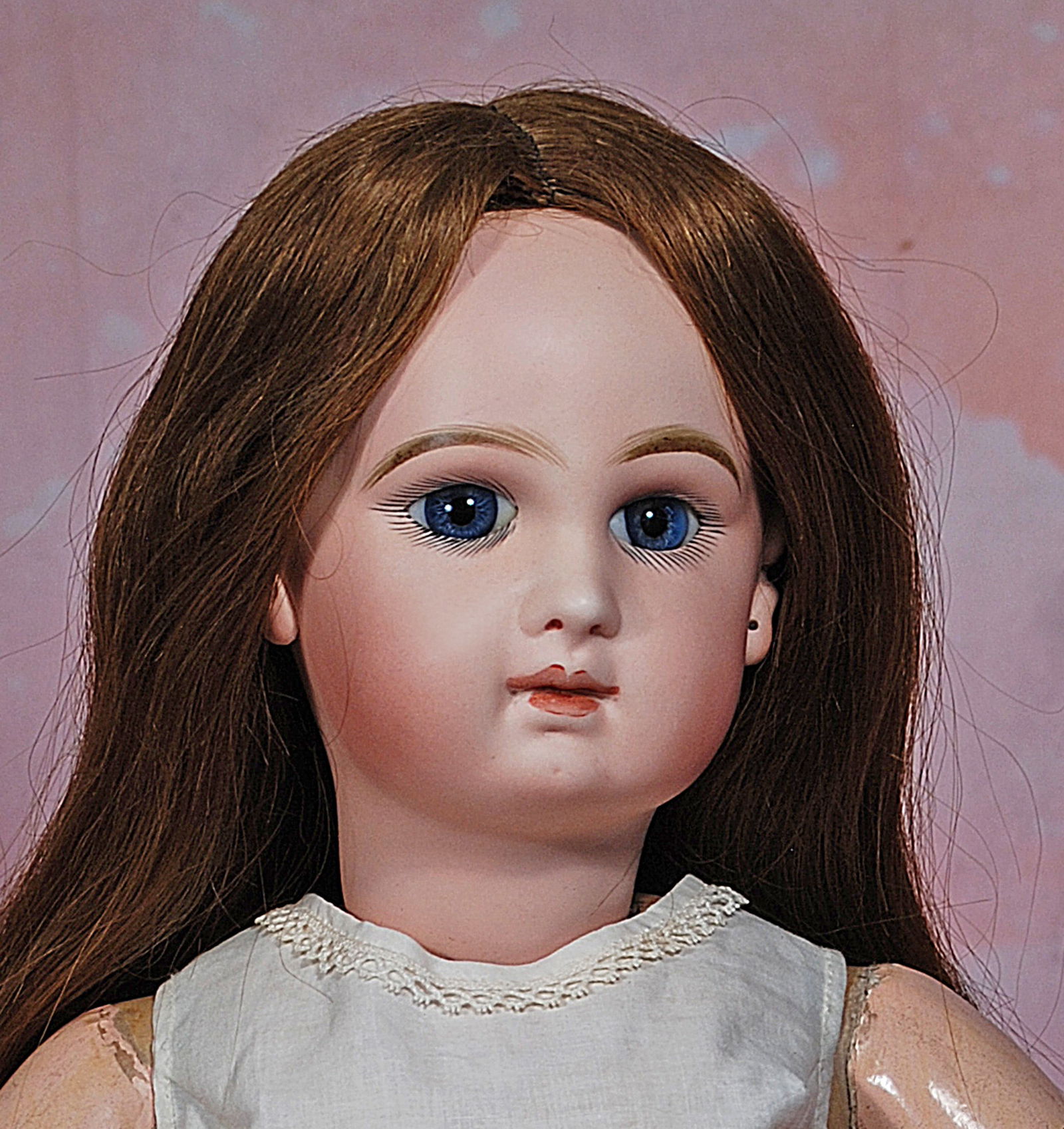FRENCH BISQUE BLUE-EYED BEBE BY JUMEAU.: 107. FRENCH BISQUE BLUE-EYED BEBE BY JUMEAU. 23”. Marks: Depose Tete Jumeau Bte SGDG 11. Bisque socket head, blue paperweight eyes, painted lashes, mauve-blushed eye shadow, eyeliner, feathered