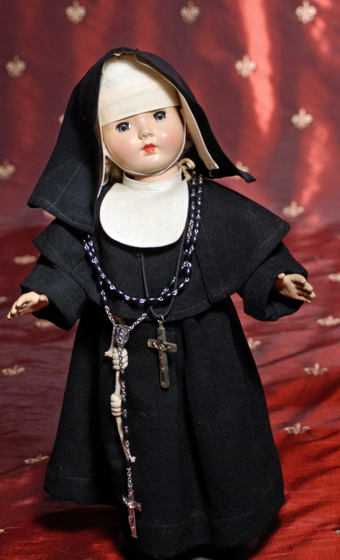 EFFANBEE NUNDOLL.: EFFANBEE HARD PLASTIC NUN DOLL. 16”. Hard plastic socket head, five-piece body, sleep eyes, closed mouth, dressed in black woolen nun habit, black stockings, leather shoes. Commentary: Very good con