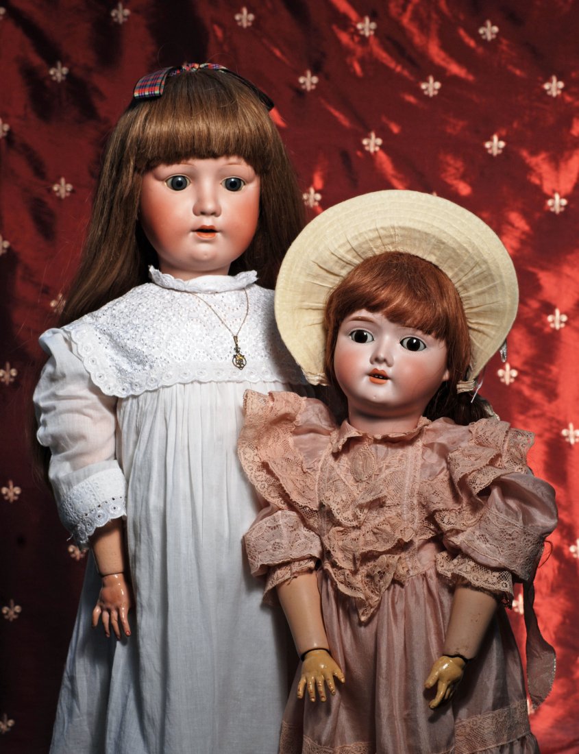 TWO GERMAN BISQUE DOLLS.: TWO GERMAN BISQUE DOLLS. Each has bisque socket head, sleep eyes, painted lashes, feathered brows, open mouth, human hair wig, composition ball-jointed body. (1) 30” doll by Max Oscar Arnold marked 