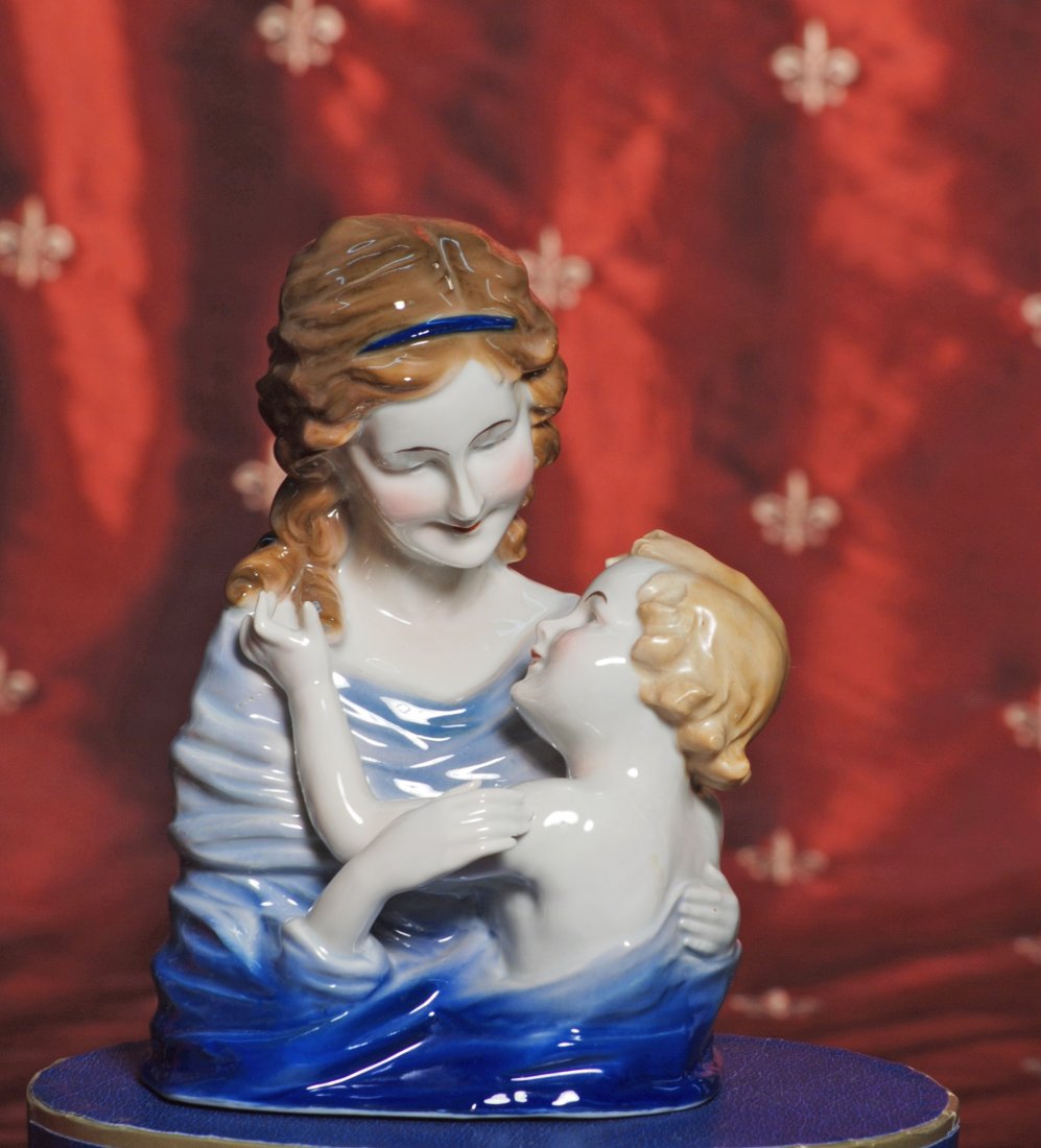 MEISSEN PORCELAIN MOTHER AND CHILD FIGURE.: MEISSEN PORCELAIN MOTHER AND CHILD FIGURE. Marks: Red crown symbol plus “M” over cross, Germany. 7”. porcelain figure of mother with shaded wavy brown hair, blue headband and shaded royal blue g