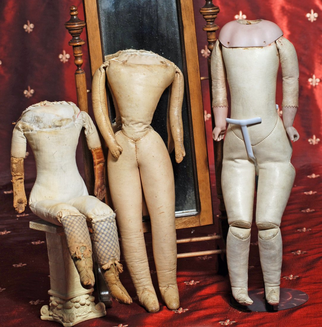 THREE ANTIQUE KID AND CLOTH DOLL BODIES: THREE ANTIQUE KID AND CLOTH DOLL BODIES. 14” Lachman type cloth body with sewn-on leather boots and leather hands; 15” French fashion kid body, unjointed, mitten-type hands, weak at waist; 15 ½��