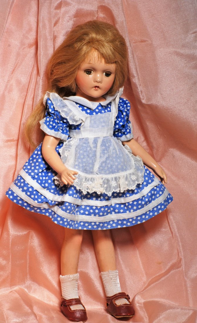 ALEXANDER WENDY ANN “ALICE IN WONDERLAND”: ALEXANDER WENDY ANN “ALICE IN WONDERLAND” COMPOSITION DOLL. Marks: Wendy Ann, Alexander, New York (doll); dress tagged Alexander Alice in Wonderland. 13”. Composition socket head on jointed comp