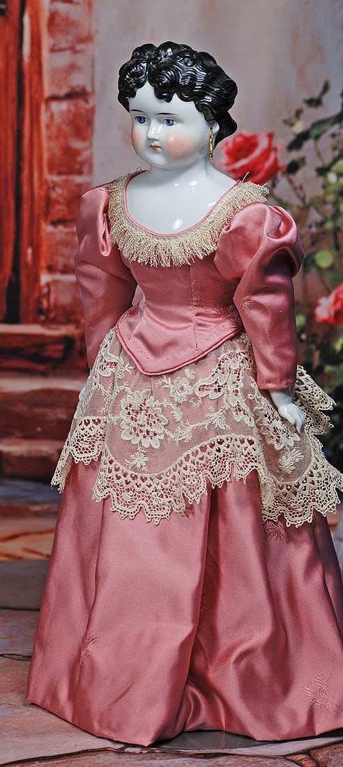 GERMAN PORCELAIN LADY WITH SCULPTED HAIR AND PIERCED EARS: GERMAN PORCELAIN LADY WITH SCULPTED HAIR AND PIERCED EARS. 18”. Porcelain shoulderhead, sculpted black hair with comb-marked detail, arranged in so-called Dolly Madison hair style with sculpted