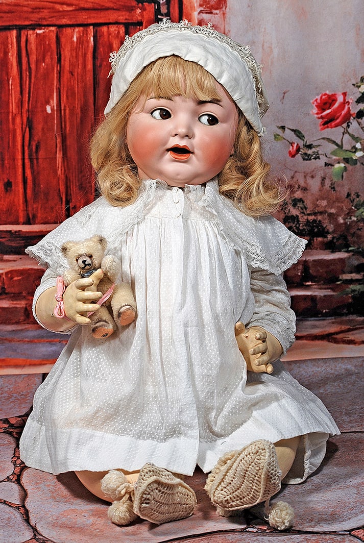 GERMAN BISQUE LIFE-SIZE, FLIRTY-EYED CHARACTER BABY BY KAMMER AND REINHARDT: GERMAN BISQUE LIFE-SIZE, FLIRTY-EYED CHARACTER BABY BY KAMMER AND REINHARDT. 26”. Marks: Simon & Halbig, K * R 126. Bisque socket head, brown flirty and sleep eyes, painted curly lashes, feather