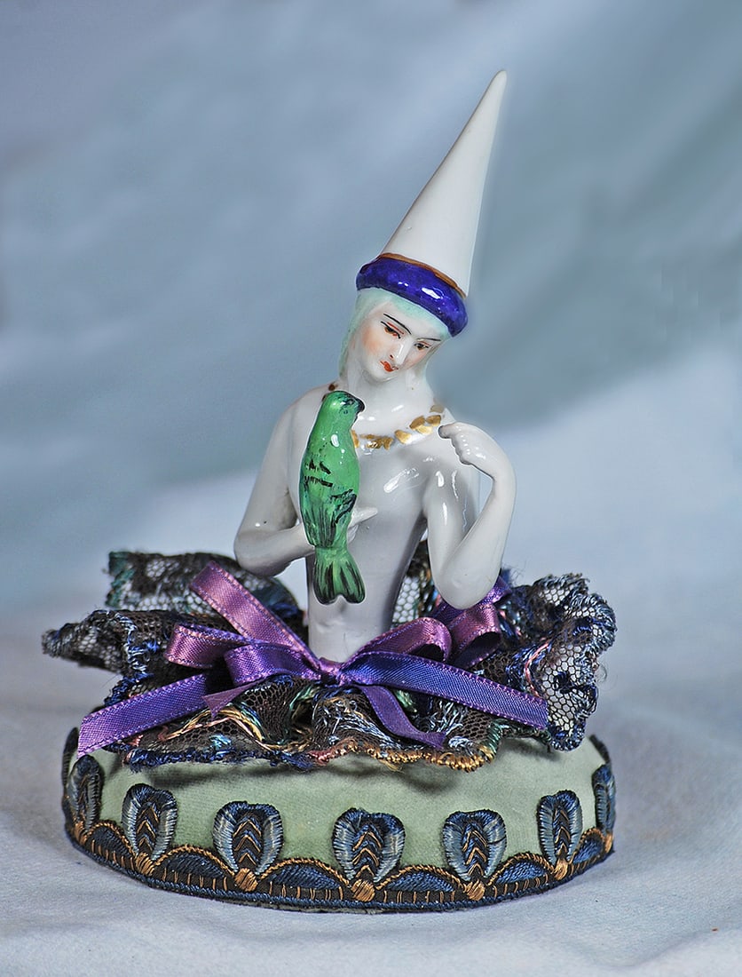 GERMAN PORCELAIN HALF DOLL MEDIEVAL LADY WITH PARROT BY DRESSEL AND KISTER: GERMAN PORCELAIN HALF DOLL MEDIEVAL LADY WITH PARROT BY DRESSEL AND KISTER. 4 ½” doll. Waist-up porcelain figure of adult nude woman with white complexion, head tilted sideways with grey ha
