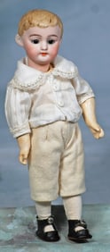 PETITE MODEL OF GERMAN BISQUE DOLL KNOWN AS “AMERICAN SCHOOL BOY”