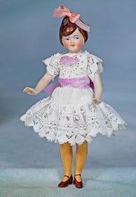 GERMAN ALL-BISQUE FLAPPER DOLL WITH SCULPTED HAIR AND YELLOW STOCKINGS