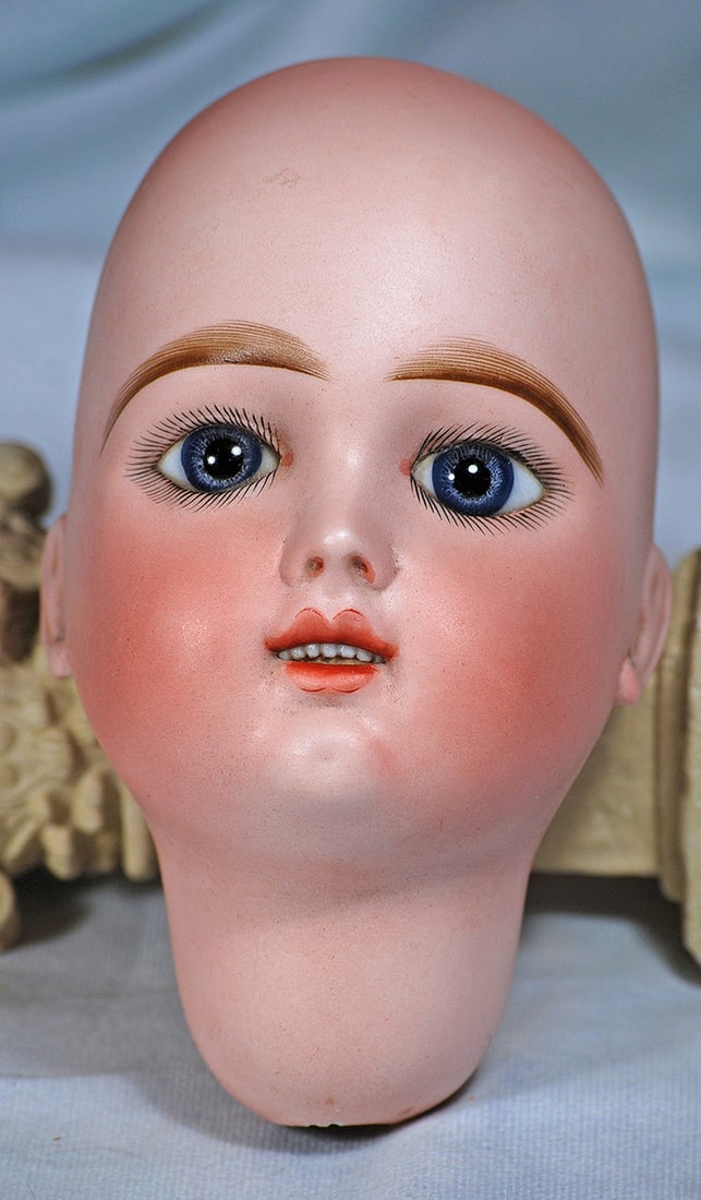 FRENCH BISQUE EDEN BEBE DOLL HEAD: FRENCH BISQUE EDEN BEBE DOLL HEAD. Marks: Eden Bebe Paris 12 Depose. Bisque socket head, blue paperweight eyes, painted lashes, feathered brows, open mouth, shaded and accented lips, upper teeth, pier