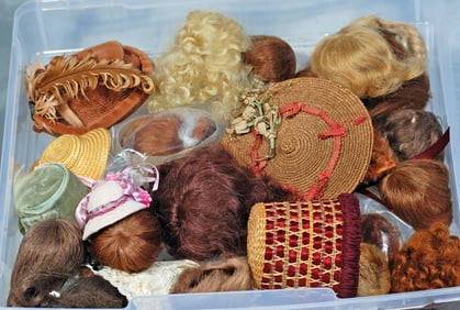 BOX OF WIGS AND BONNETS FOR SMALL DOLLS.