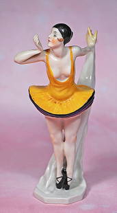 GERMAN PORCELAIN FLAPPER AS BALLERINA: GERMAN PORCELAIN FLAPPER AS BALLERINA. 7 ¼”. Porcelain figure of ballerina with black skull cap and wisps of brown hair, painted features, right hand posed as if blowing a kiss and the