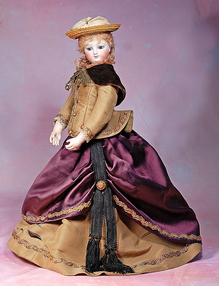 FRENCH BISQUE POUPEE WITH ORIGINAL KID-OVER-WOODEN BODY AND DEHORS NECK ARTICULATION: FRENCH BISQUE POUPEE WITH ORIGINAL KID-OVER-WOODEN BODY AND DEHORS NECK ARTICULATION. 17”. Marks: None visible. Bisque swivel head on bisque shoulderplate, Dehors neck articulation which allows