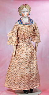 GERMAN BISQUE LADY WITH SCULPTED HAIR AND BODICE: GERMAN BISQUE LADY WITH SCULPTED HAIR AND BODICE. 23”. Marks: None. Bisque shoulderhead with sculpted blonde hair arranged in cluster of tiny curls at the front, sides drawn away from face