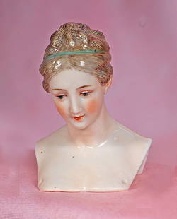BISQUE DOLL HEAD WITH SCULPTED HAIR BY DRESSEL AND KISTER: BISQUE DOLL HEAD WITH SCULPTED HAIR BY DRESSEL AND KISTER. 3 &#189;&#8221;. Marks: blue bishop&#8217;s staff stamp. Pink-toned porcelain shoulderhead of lady with sculpted light brown hair in braided
