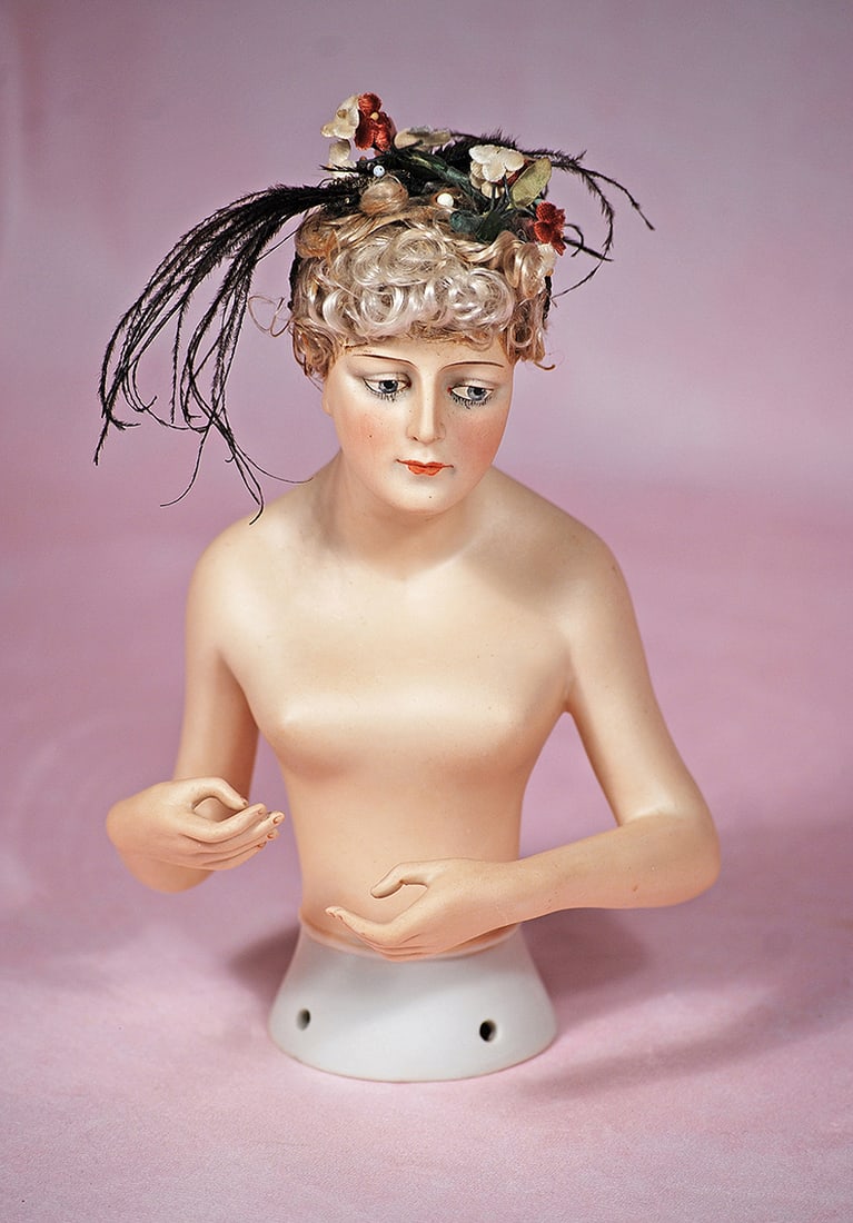 LARGE GERMAN BISQUE HALF DOLL BY GOEBEL: LARGE GERMAN BISQUE HALF DOLL BY GOEBEL. 8”. Marks: Goebel trademark symbol/ Germany. Waist-up bisque half figure of nude lady with mohair wig, painted features, downcast gray outlined eyes with