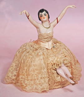 GERMAN PORCELAIN FLAPPER HALF AS PINCUSHION: GERMAN PORCELAIN FLAPPER HALF AS PINCUSHION. 4” doll 6 ½” overall. Waist-up porcelain figure of nude lady with arms outstretched, sculpted black hair, painted features, outlined