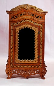 FRENCH WOODEN ARMOIRE WITH ELABORATE CARVING AND MIRRORED FRONT