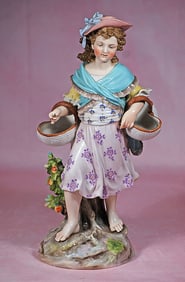 GERMAN PORCELAIN FIGURINE OF BAREFOOT GIRL WITH BASKETS BY MEISSEN