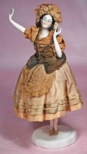 GERMAN PORCELAIN PINCUSHION DOLL ATTRIBUTED TO CARL SCHEIDER: GERMAN PORCELAIN PINCUSHION DOLL ATTRIBUTED TO CARL SCHEIDER. 10&#8221;. Waist-up porcelain lady with sculpted black hair, painted features, brown outlined eyes, gray eye shadow, tapered brows, closed