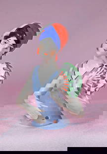 GERMAN PORCELAIN HALF DOLL WITH FAN: GERMAN PORCELAIN HALF DOLL WITH FAN. 3 ½”. Waist-up porcelain half doll with red turban with blue band and feather, red earrings, black side curls, painted features, painted blue bodice,