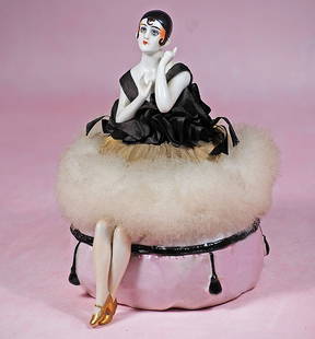 GERMAN PORCELAIN HALF DOLL ?PIERETTE? AS POWDER PUFF ON POWDER BOX: GERMAN PORCELAIN HALF DOLL “PIERETTE” AS POWDER PUFF ON POWDER BOX. 7 ½” overall. Waist-up porcelain nude half-doll with sculpted cap and dark brown curls, painted and