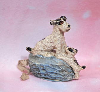 NOVELTY FIGURAL TAPE MEASURE: NOVELTY FIGURAL TAPE MEASURE. 2 &#188;&#8221;. Featuring sculpted black and white bisque pups posed on blue bisque oval-shaped base with retractable cloth tape measure. Commentary: Unique novelty item