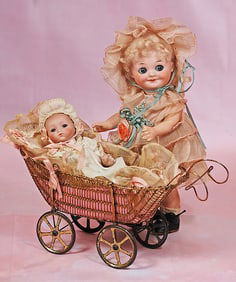 TINY GERMAN ALL-BISQUE INFANT IN ANTIQUE WIRE CARRIAGE