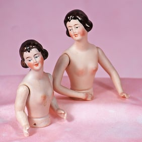 PAIR OF GERMAN BISQUE HALF DOLLS WITH JOINTED ARMS