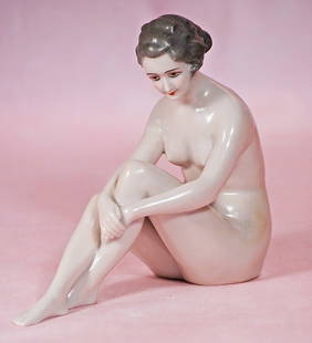 GERMAN PORCELAIN SEATED LADY BY DRESSEL AND KISTER: GERMAN PORCELAIN SEATED LADY BY DRESSEL AND KISTER. 6&#8221; x 7&#8221;. Marks: blue bishops staff/Germany. One-piece porcelain figure of nude seated lady, her legs bent and crossed at the knees, and